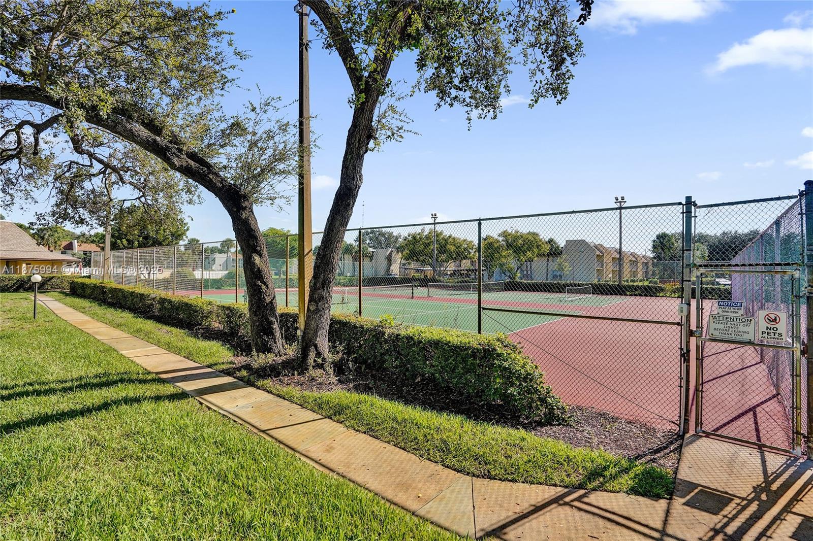 2975 Southwest 22nd Avenue, Unit 102 Delray Beach, FL 33445 - Photo 59 of 73 a view of a yard with a tree