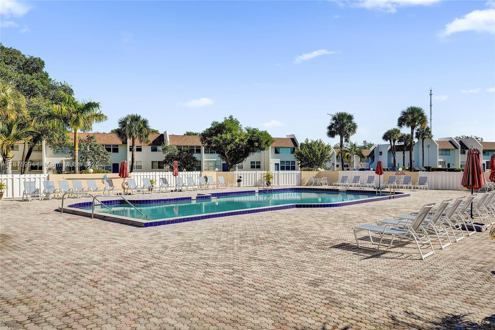2975 Southwest 22nd Avenue, Unit 102 Delray Beach, FL 33445 - Photo 60 of 73 a view of a swimming pool with an outdoor seating