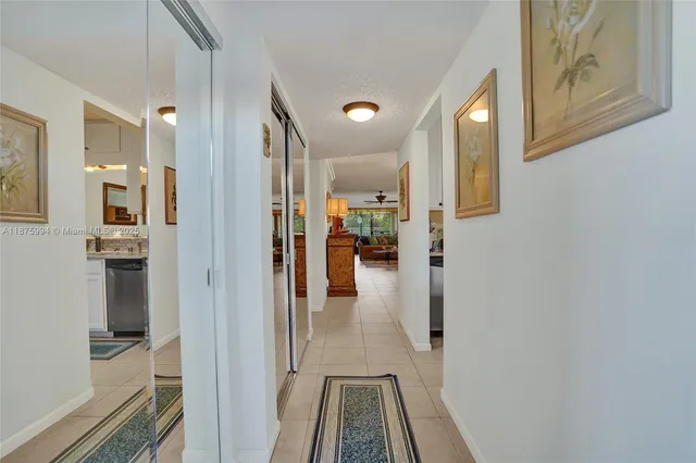 a kitchen with stainless steel appliances granite countertop a refrigerator a stove a microwave oven with white cabinets