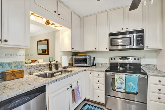 a kitchen with a sink stove and microwave