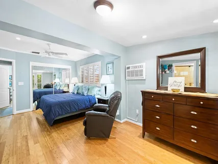 a spacious bedroom with a bed and window