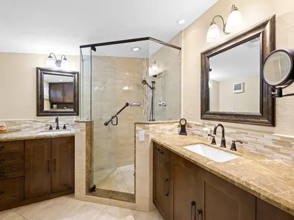a bathroom with a double vanity sink mirror and