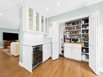 a kitchen with stainless steel appliances a stove top oven a sink and a refrigerator