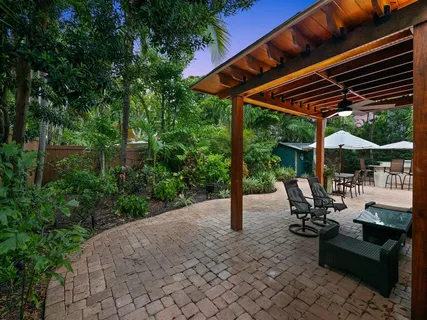 a view of patio with a table chairs and a backyard