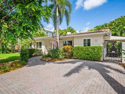 a front view of a house with yard and green space