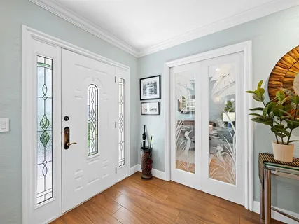 a view of an entryway with wooden floor and front door