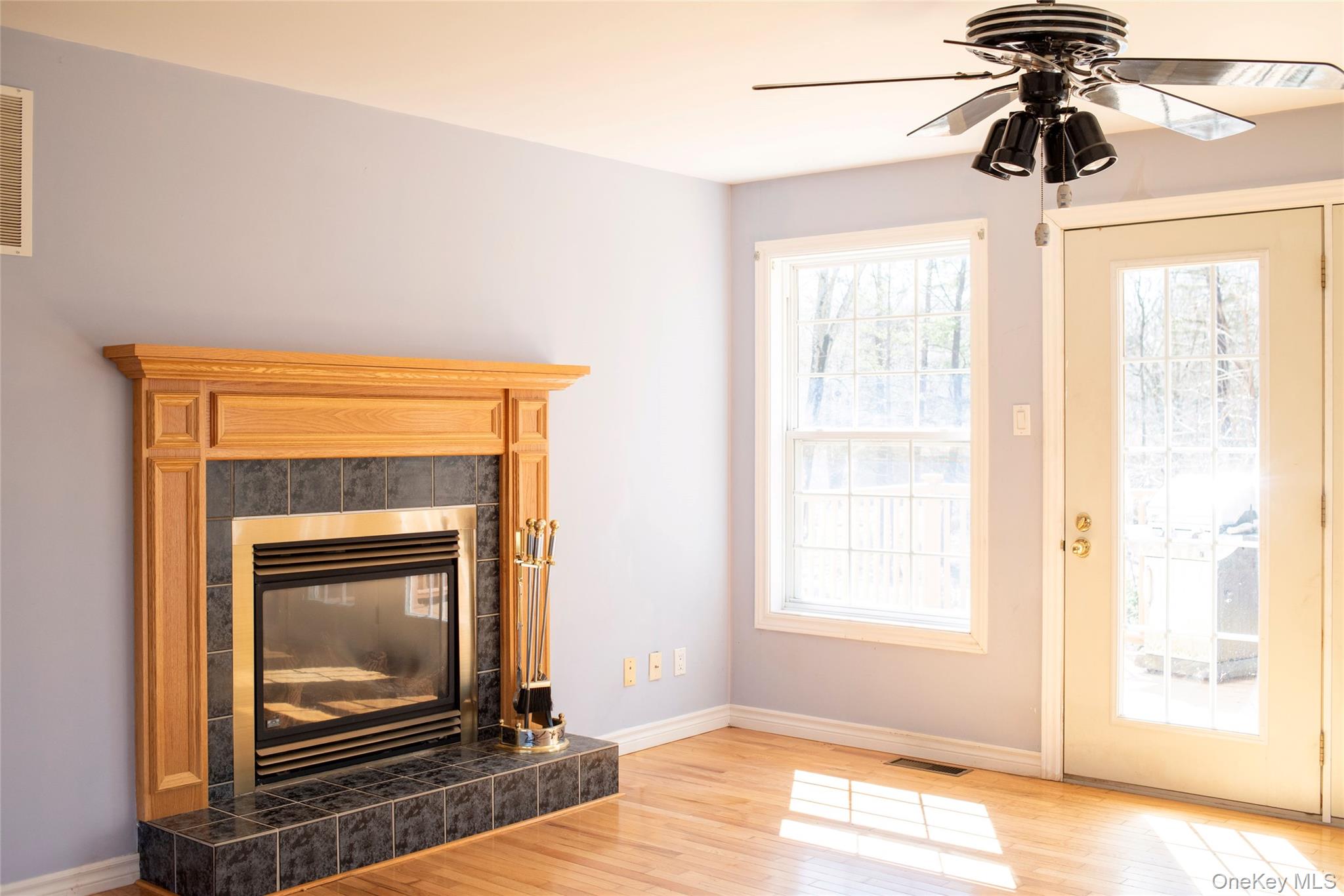 212 Rhinecliff Road Rhinebeck, NY 12572 - Photo 6 of 18 a living room with a fireplace and wooden floor