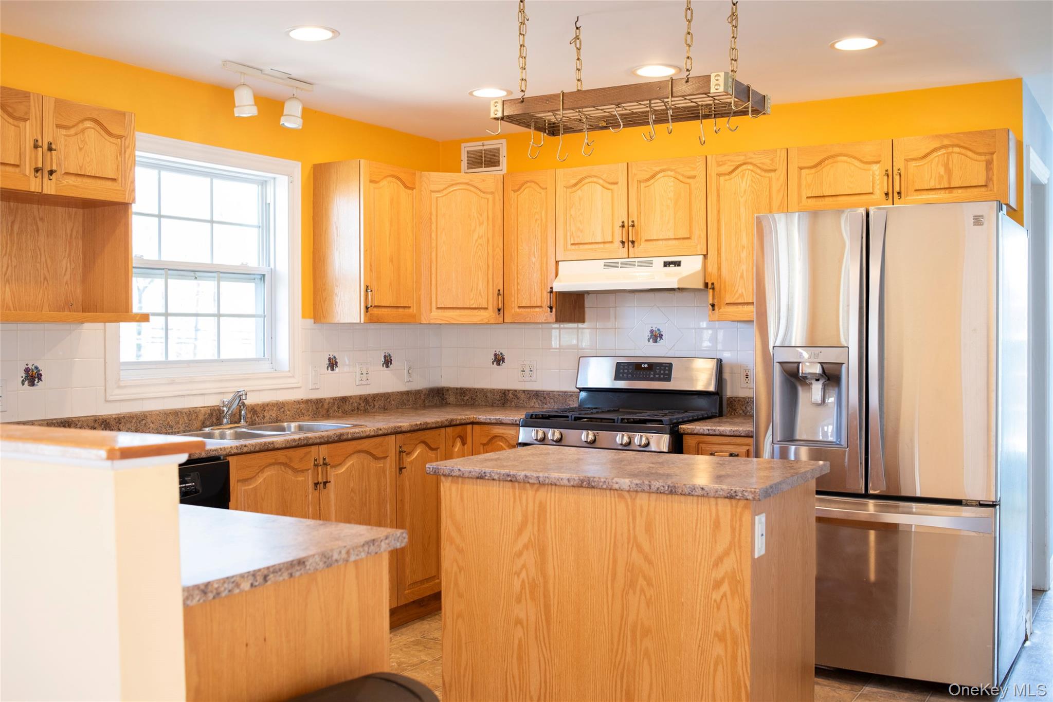 212 Rhinecliff Road Rhinebeck, NY 12572 - Photo 9 of 18 a kitchen with stainless steel appliances a refrigerator a sink a stove and white cabinets with wooden floor