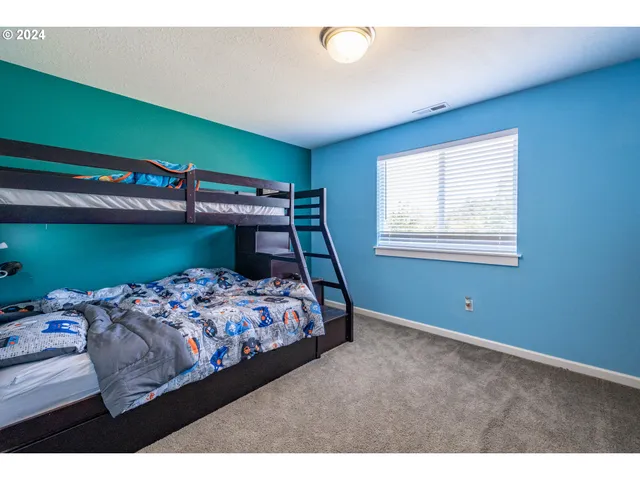 a bedroom with a bed and window