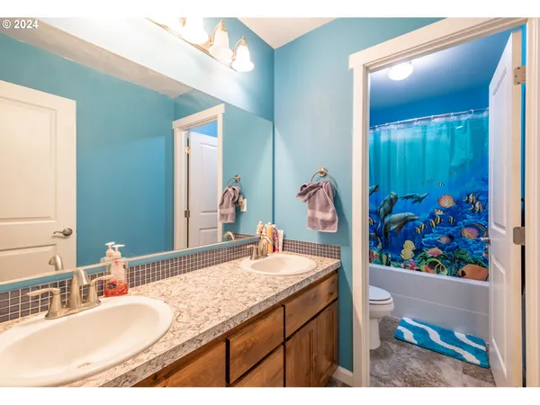 a bathroom with a granite countertop sink a mirror and a view of bathroom