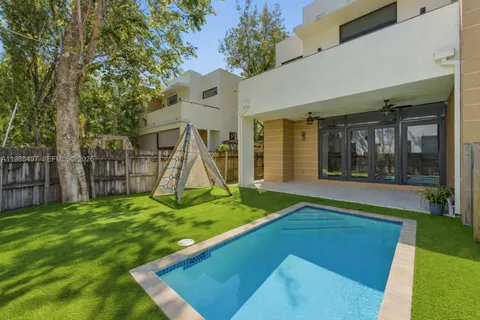 a view of an house with backyard porch and sitting area