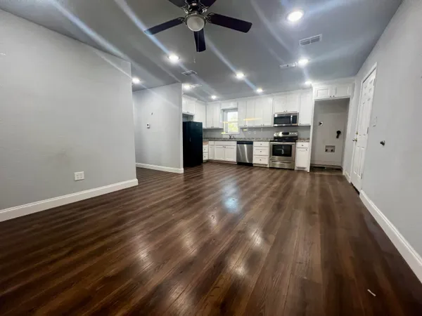 a kitchen with stainless steel appliances a refrigerator and a stove top oven