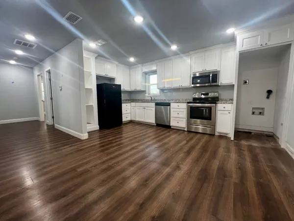 a kitchen with stainless steel appliances a refrigerator and a stove top oven