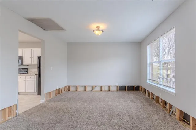 a view of an empty room and a window