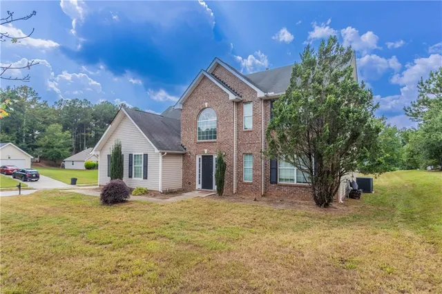 a front view of a house with garden