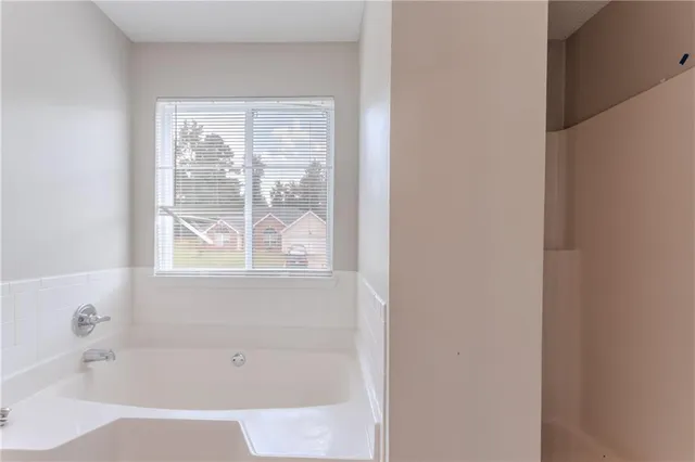 a white bath tub sitting next to a window