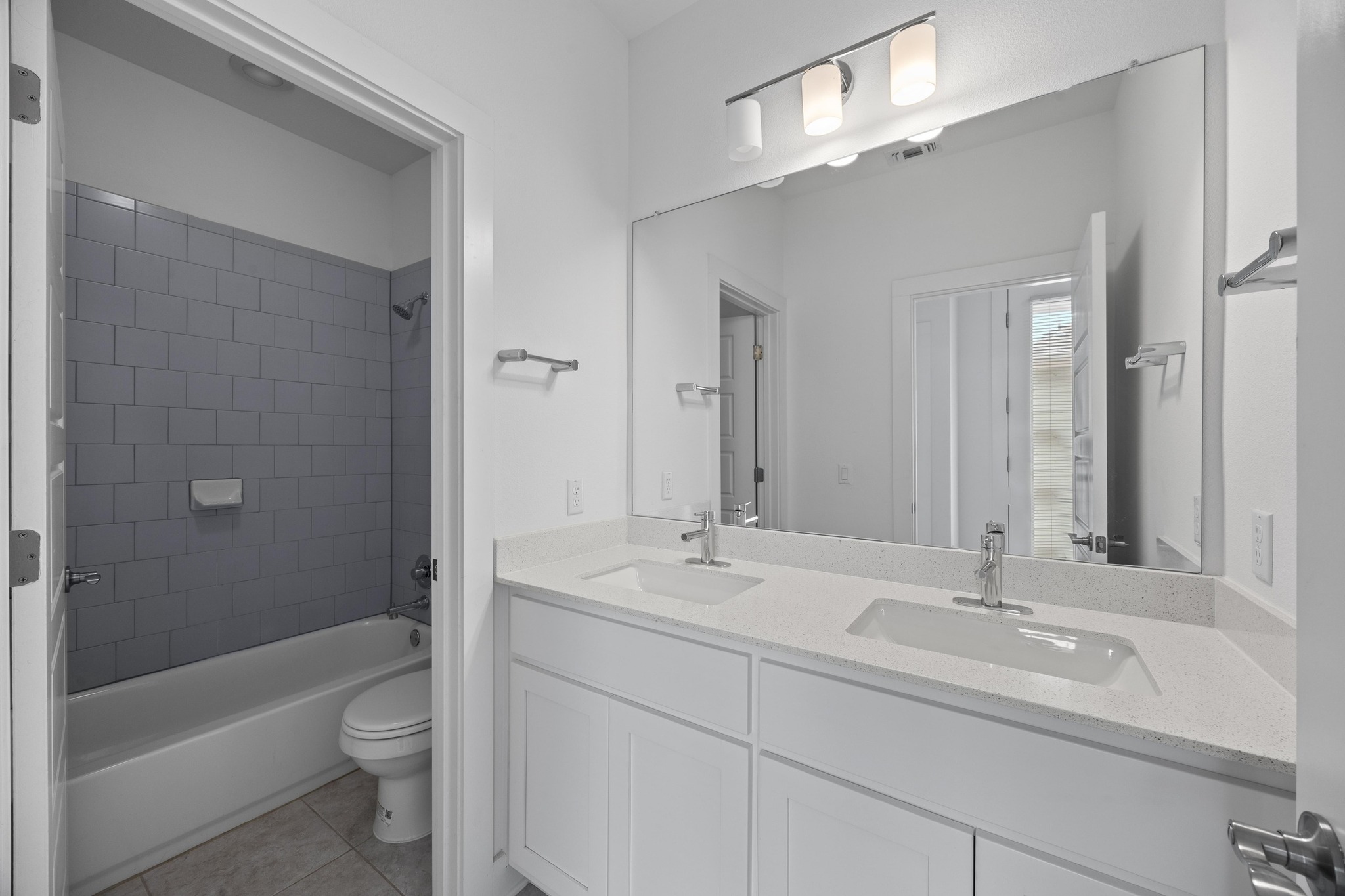 2222 Simond Avenue, Unit E Austin, TX 78723 - Photo 24 of 28 The secondary upstairs bathroom has a dual-sink bathroom.