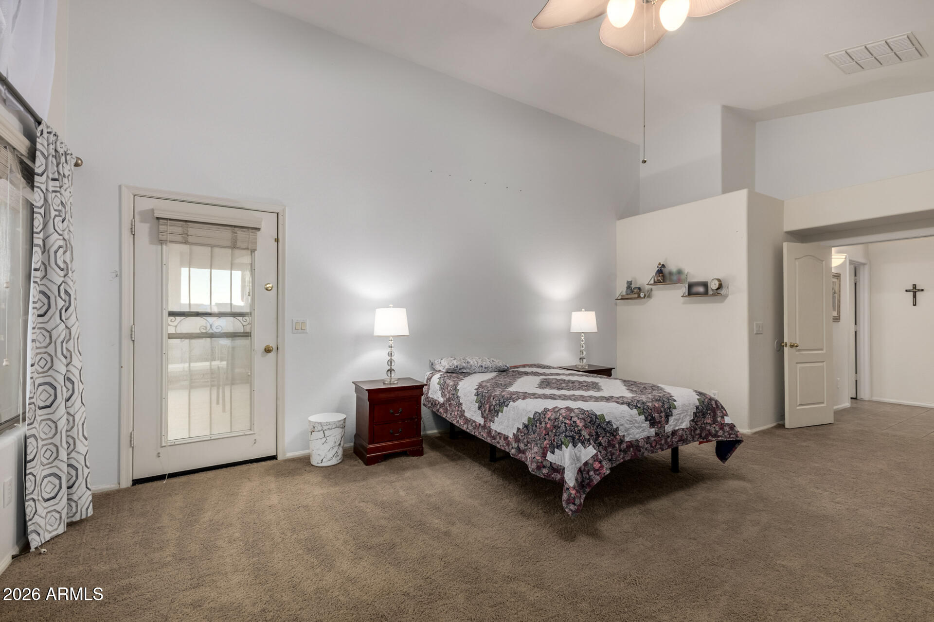 935 West Gascon Road San Tan Valley, AZ 85143 - Photo 19 of 43 a spacious bedroom with a bed and a cabinets