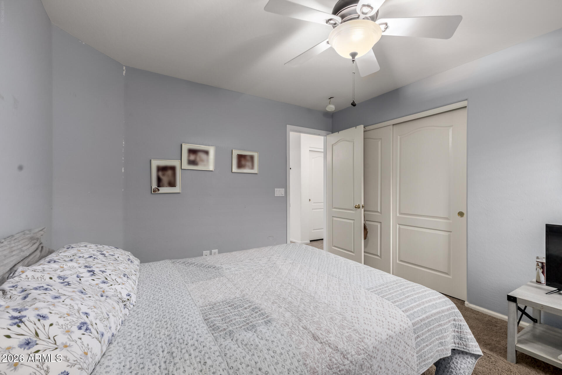 935 West Gascon Road San Tan Valley, AZ 85143 - Photo 25 of 43 a bedroom with a bed and a chandelier