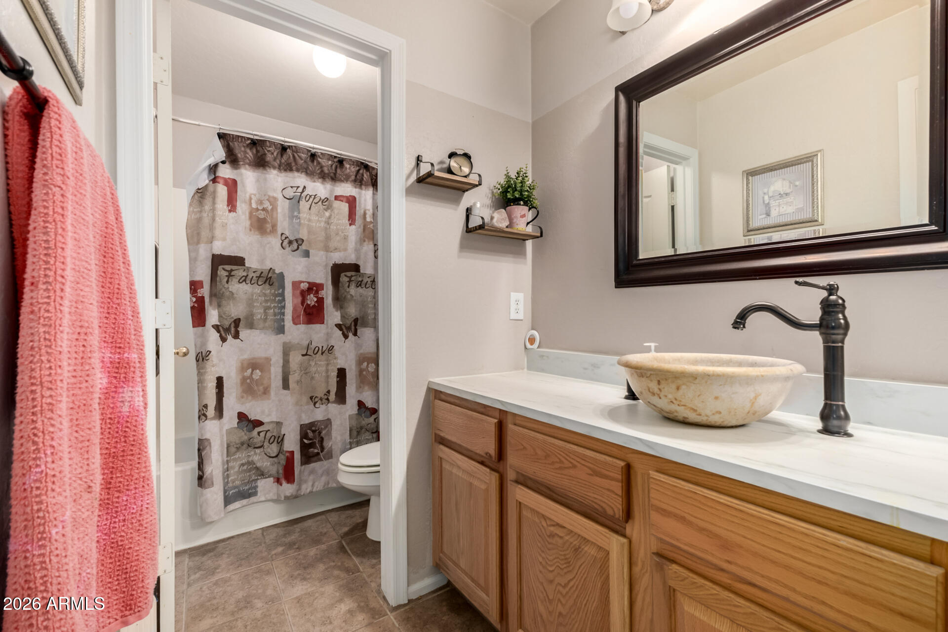 935 West Gascon Road San Tan Valley, AZ 85143 - Photo 26 of 43 a bathroom with a sink a toilet and shower curtain