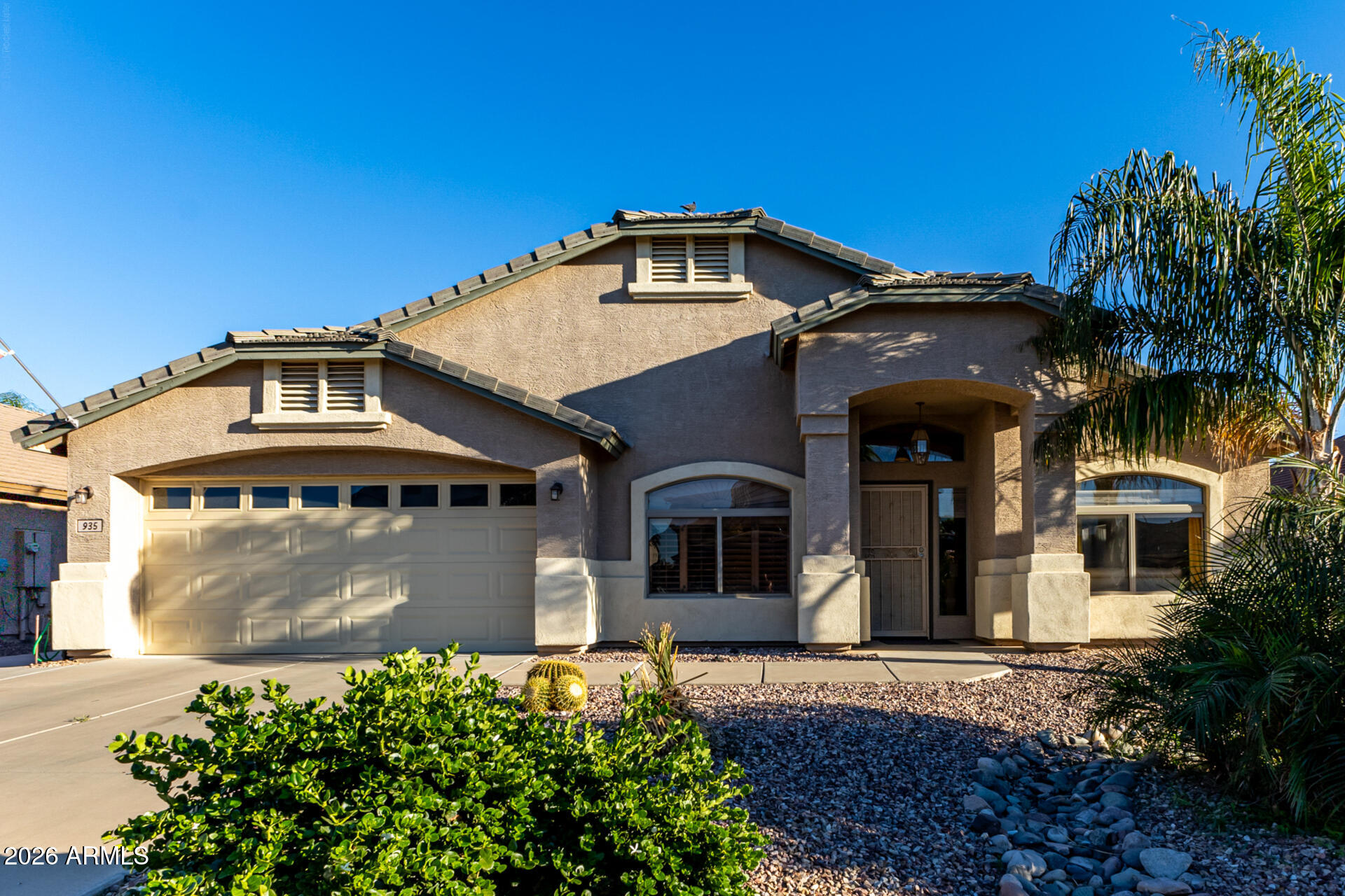 935 West Gascon Road San Tan Valley, AZ 85143 - Photo 3 of 43 a front view of a house with a yard