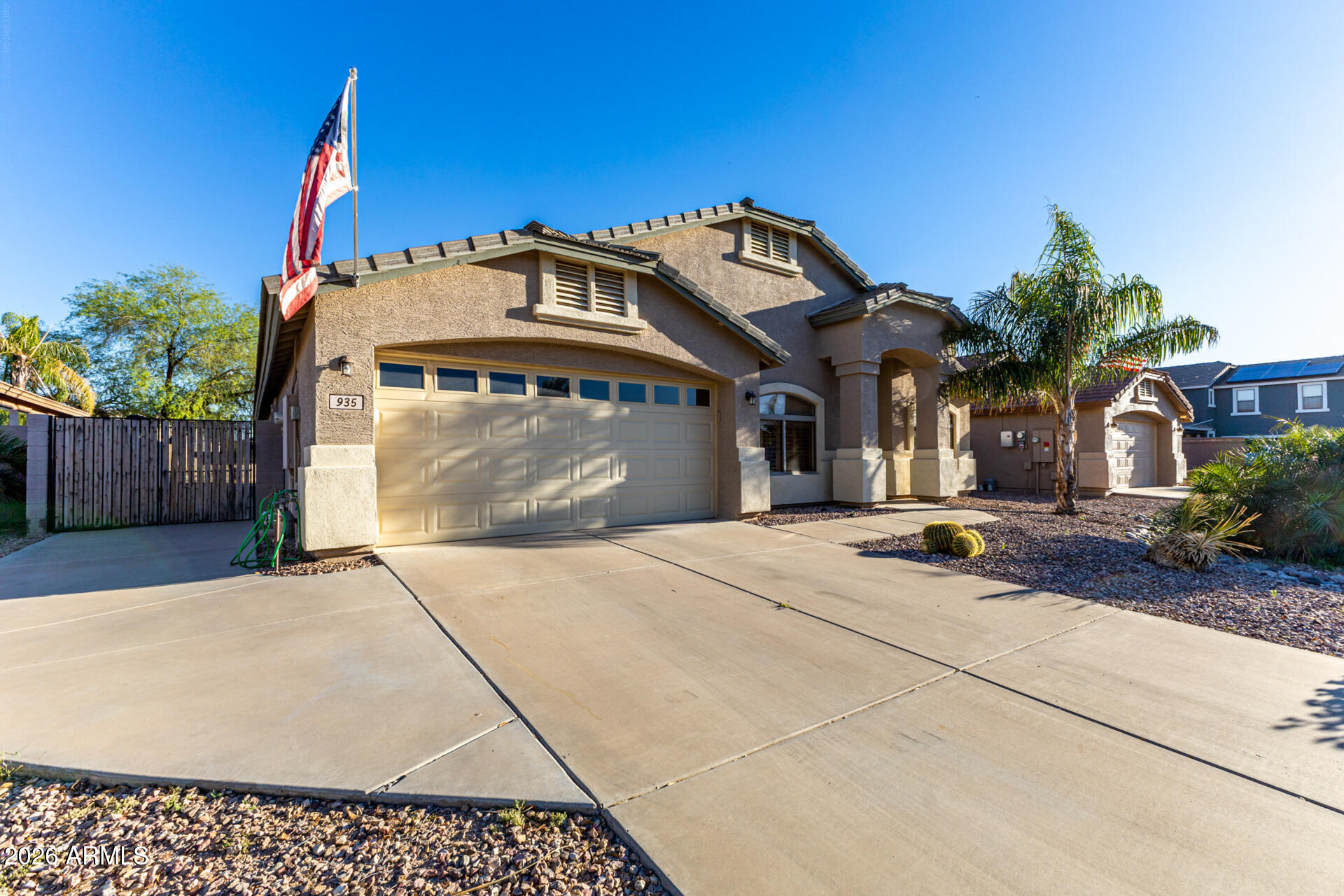 935 West Gascon Road San Tan Valley, AZ 85143 - Photo 4 of 43 a front view of a house with a yard