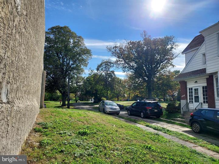 4626 Pilling Street Philadelphia, PA 19124 - Photo 4 of 6 a front view of a house with a garden and trees