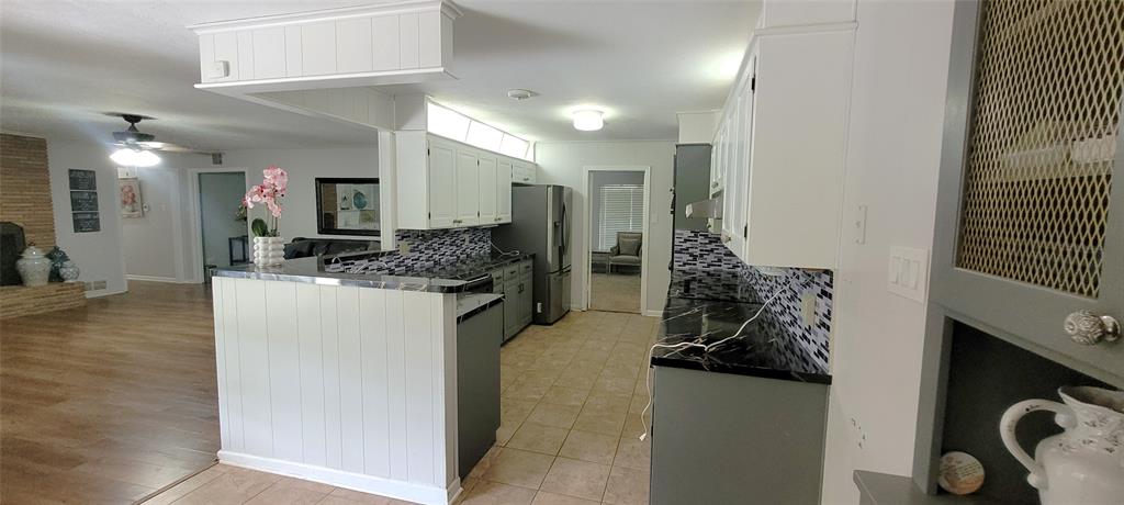 204 Overhill Drive Waxahachie, TX 75165 - Photo 11 of 40 a kitchen with a refrigerator and a sink