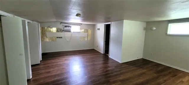 a view of a kitchen with wooden floor and a refrigerator