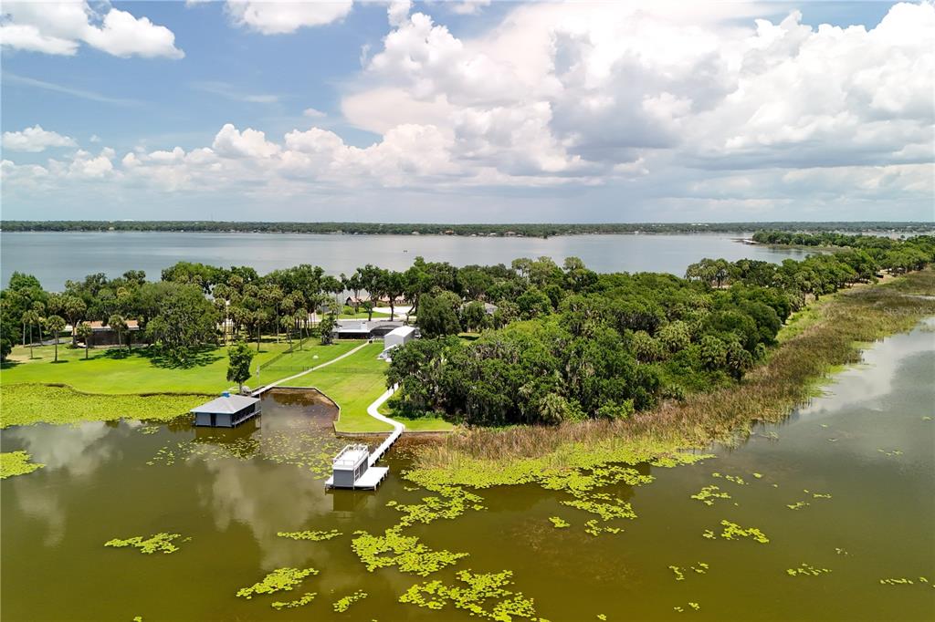 16948 Deer Island Road Tavares, FL 32778 - Photo 56 of 67 a view of a lake with houses in the back