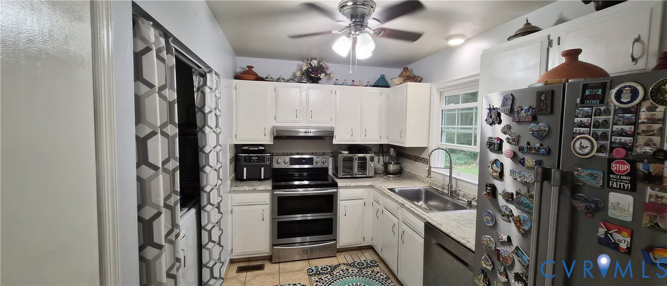 12409 Locustgrove Road Henrico, VA 23238 - Photo 25 of 40 White cabinetry with chrome hardware, stainless st