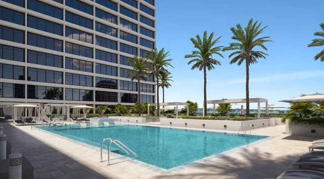 a swimming pool with outdoor seating and yard