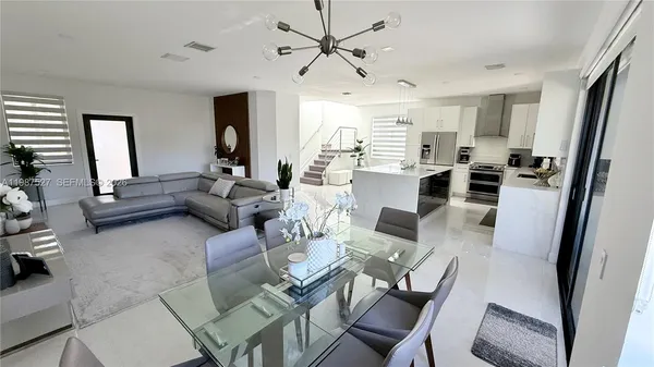 a living room with furniture and a chandelier