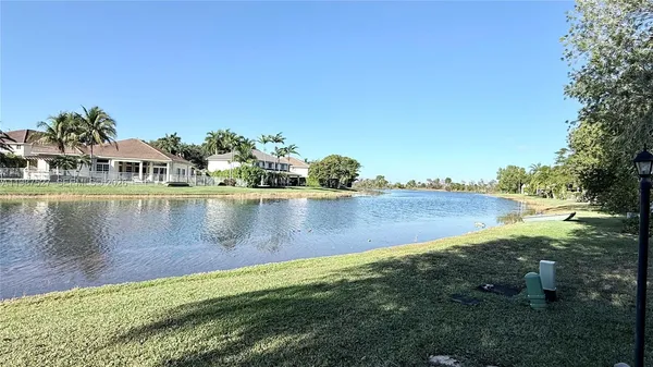 a view of a lake with houses in the back