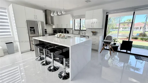 a large kitchen with stainless steel appliances lots of counter top space and cabinets