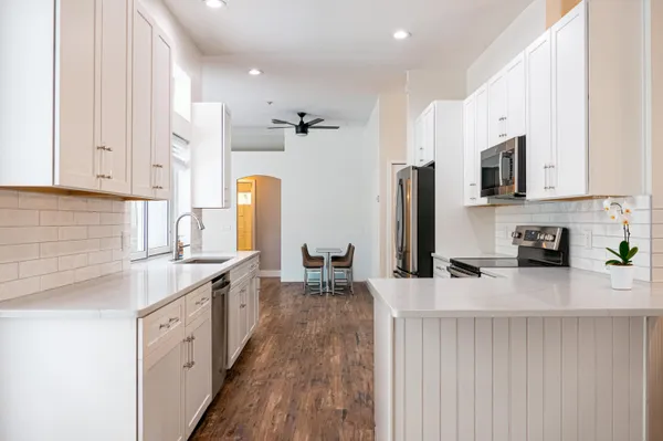 a kitchen with stainless steel appliances granite countertop a sink stove and refrigerator