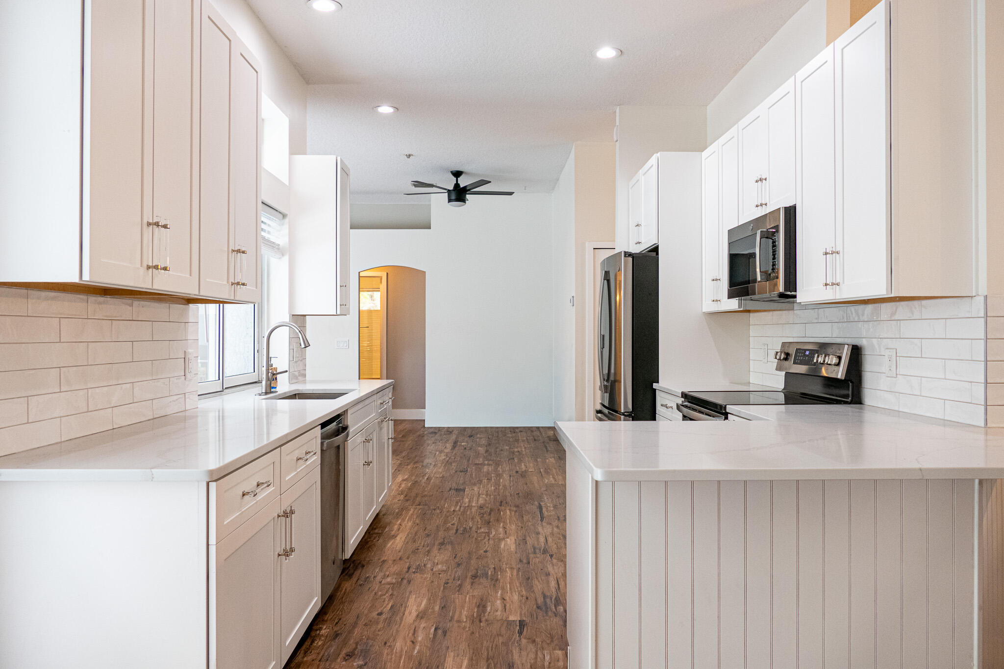 7685 Pleasant Ridge Court Stuart, FL 34997 - Photo 12 of 66 a kitchen with stainless steel appliances granite countertop a sink stove and refrigerator