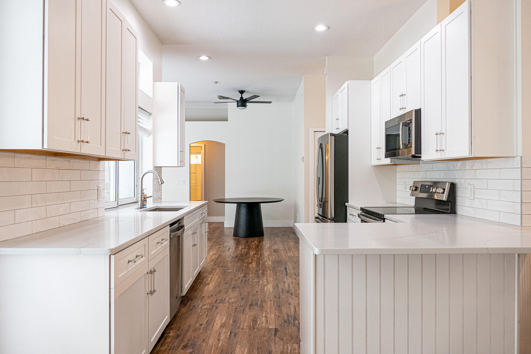 7685 Pleasant Ridge Court Stuart, FL 34997 - Photo 13 of 66 a kitchen with stainless steel appliances granite countertop a sink stove and refrigerator