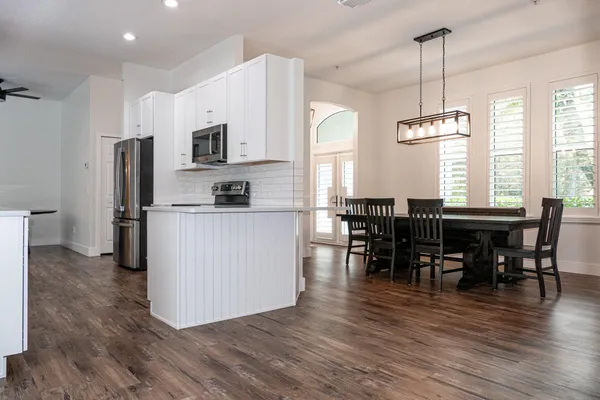 a kitchen with stainless steel appliances a refrigerator stove and microwave