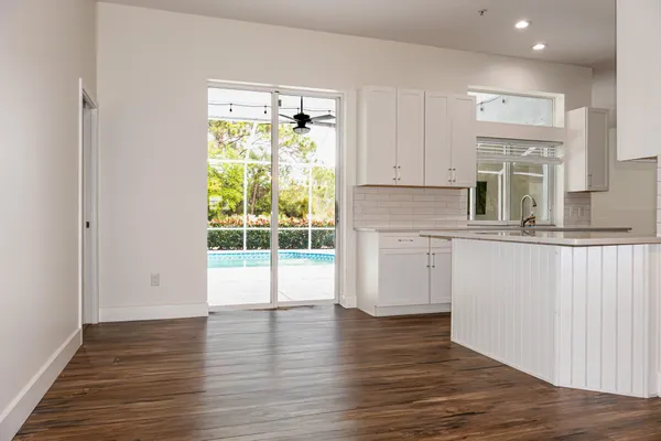 a view of a livingroom with wooden floor and a flat screen tv