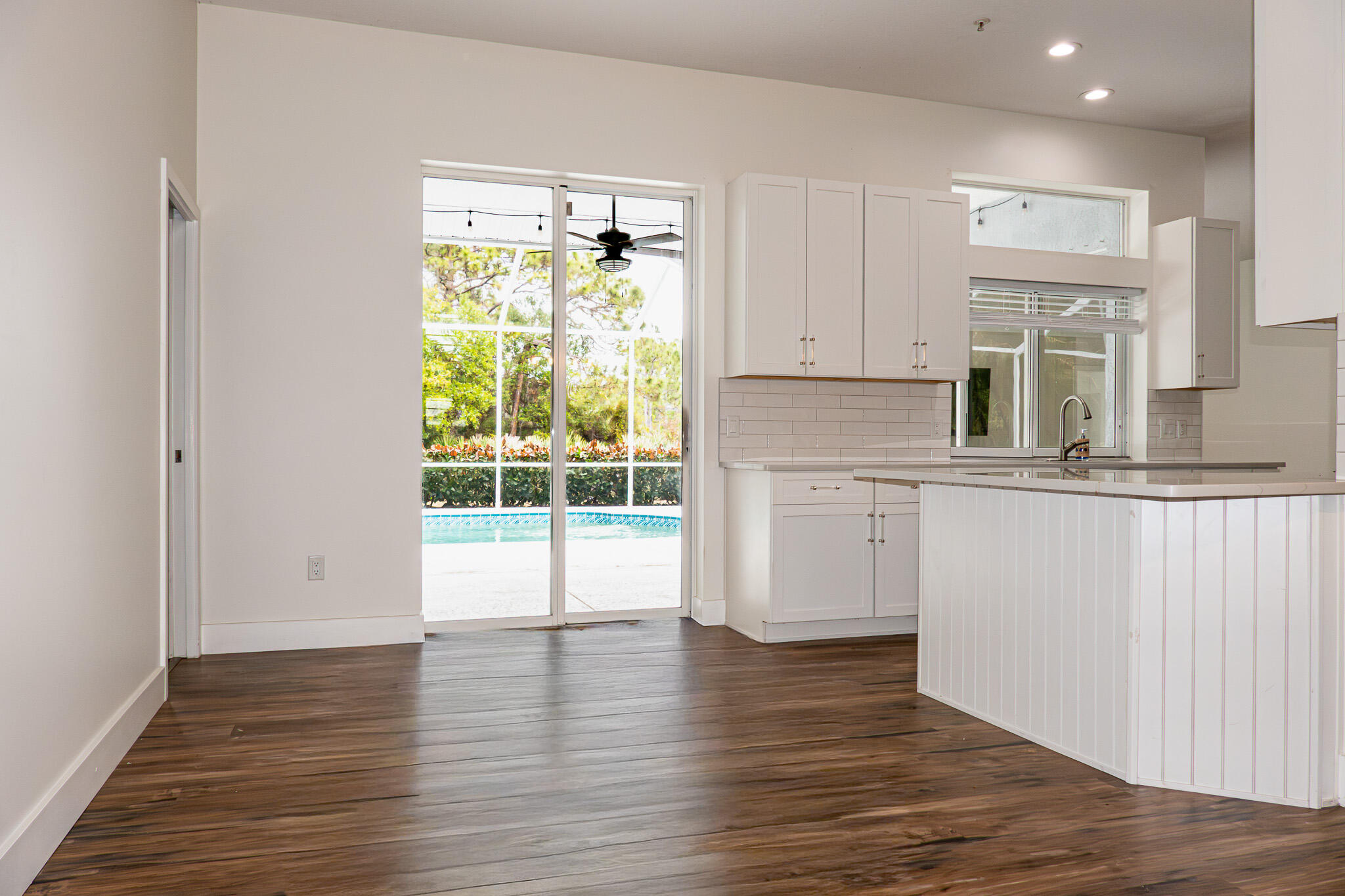 7685 Pleasant Ridge Court Stuart, FL 34997 - Photo 15 of 66 a kitchen with wooden floors and white walls