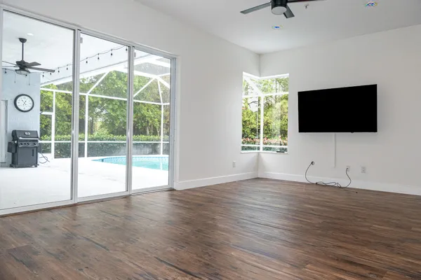 a view of empty room with wooden floor