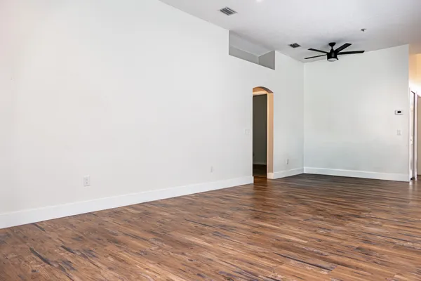 a view of a kitchen with wooden floor and a window