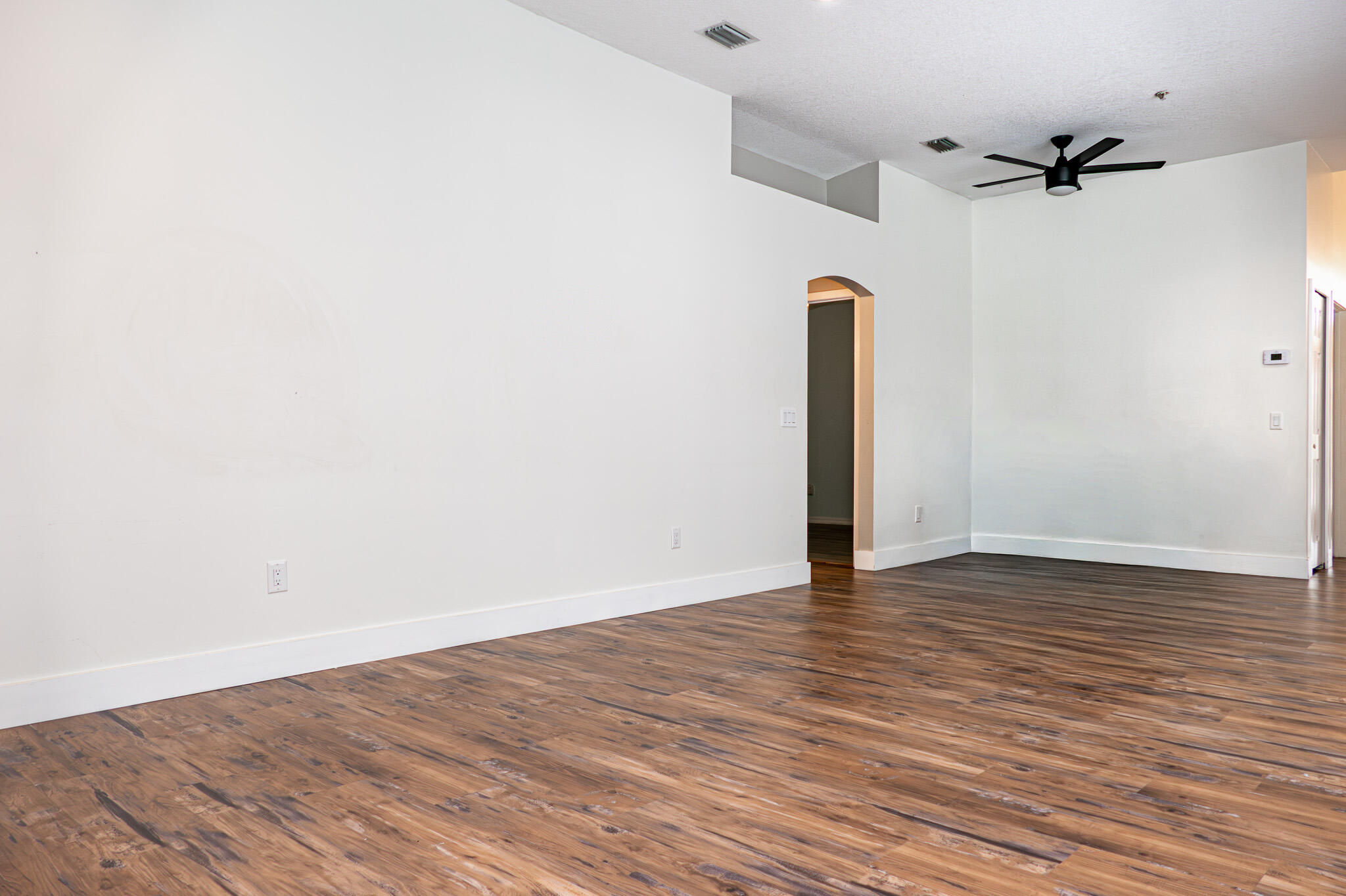 7685 Pleasant Ridge Court Stuart, FL 34997 - Photo 19 of 66 a view of empty room with wooden floor