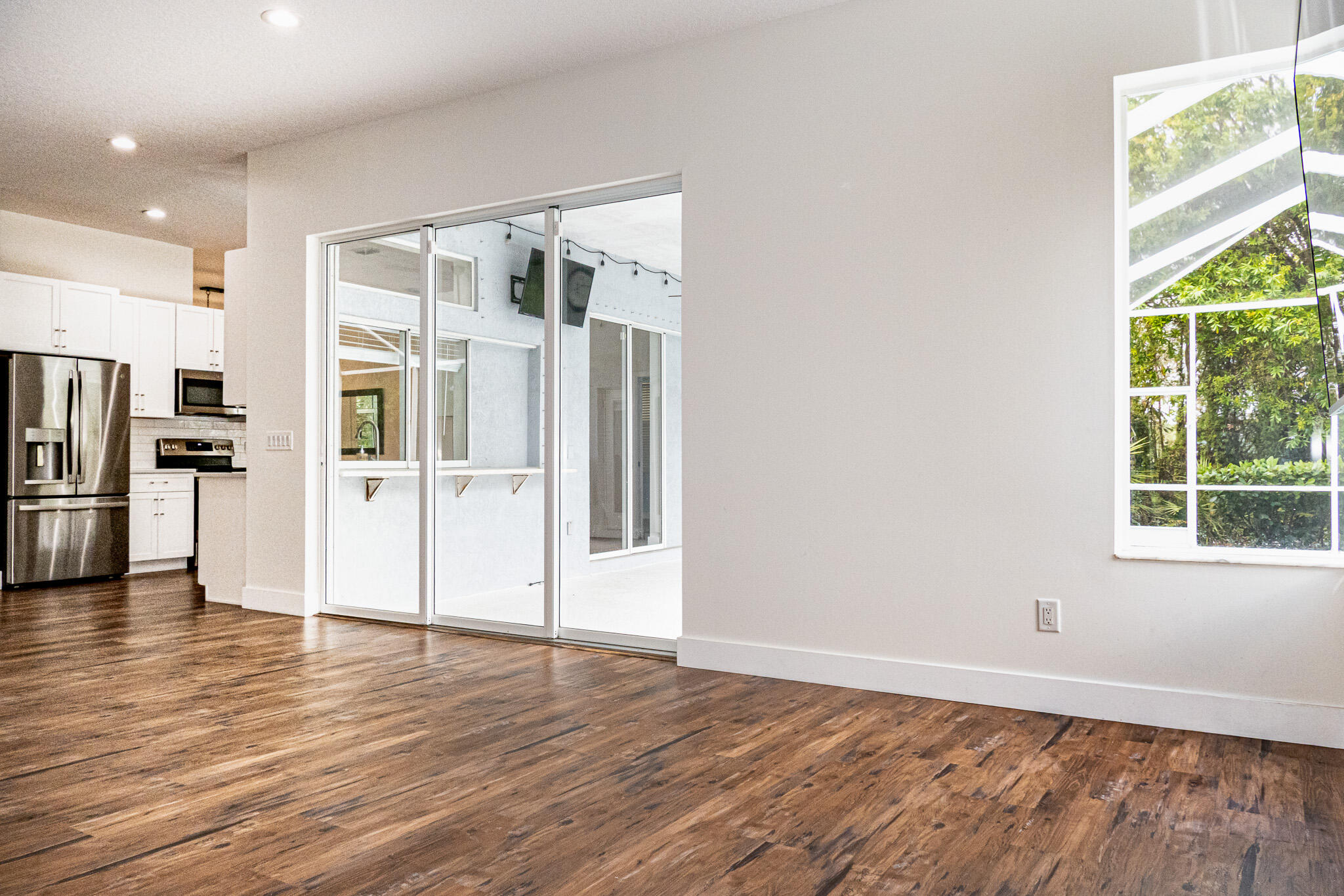 7685 Pleasant Ridge Court Stuart, FL 34997 - Photo 21 of 66 a view of a kitchen with wooden floor and a window