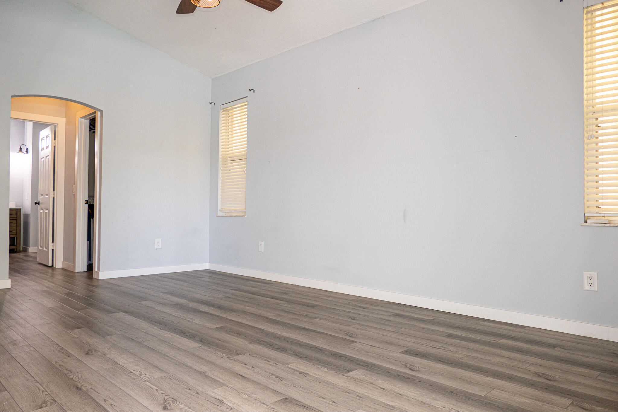 7685 Pleasant Ridge Court Stuart, FL 34997 - Photo 23 of 66 an empty room with wooden floor and windows