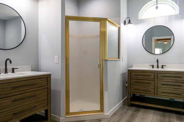 a bathroom with a sink a mirror and a shower