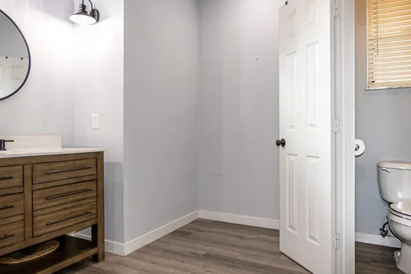 a view of a bedroom with wooden floor and cabinet