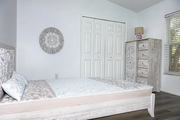 an empty room with wooden floor and a window