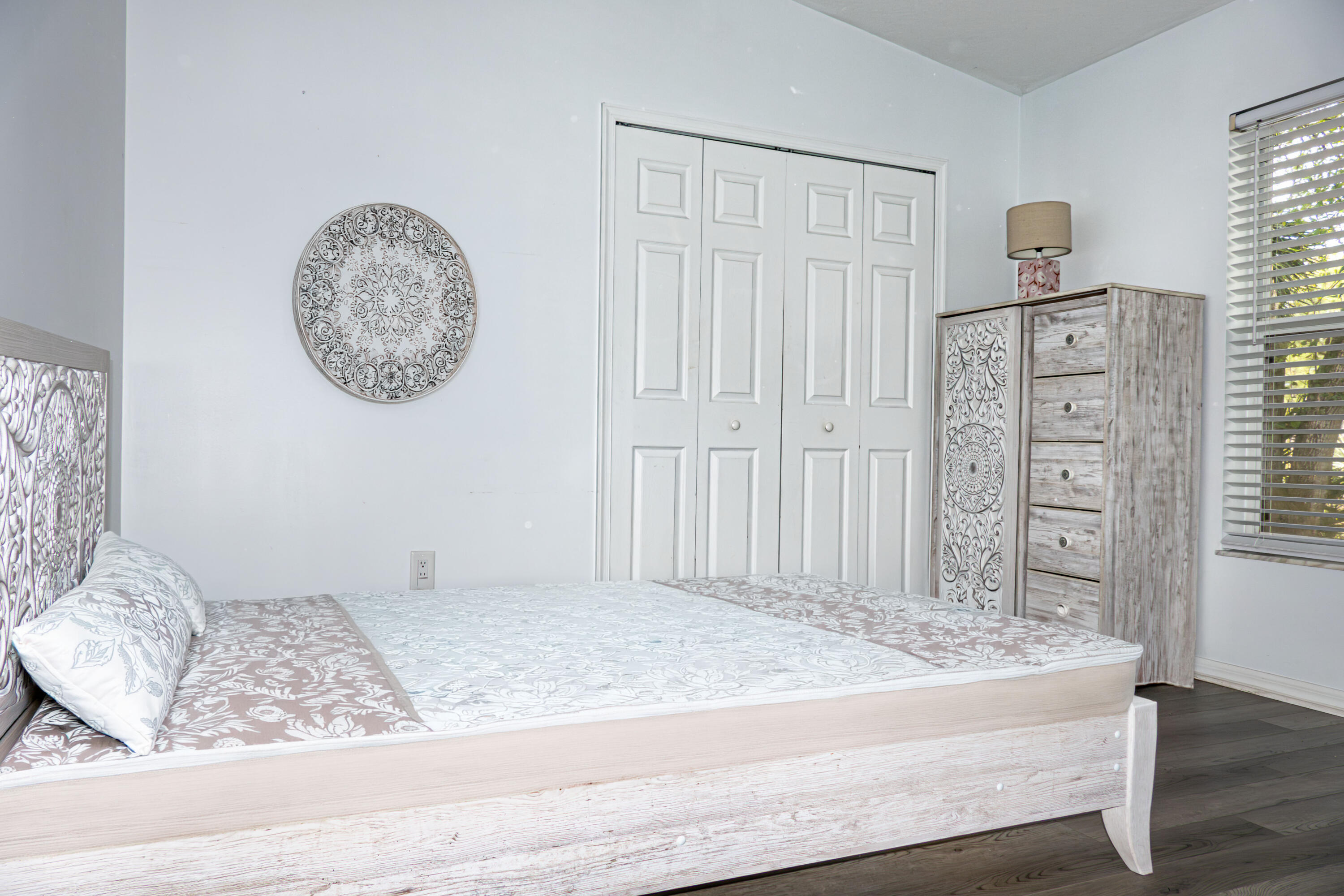 7685 Pleasant Ridge Court Stuart, FL 34997 - Photo 28 of 66 a view of a bedroom with wooden floor and cabinet